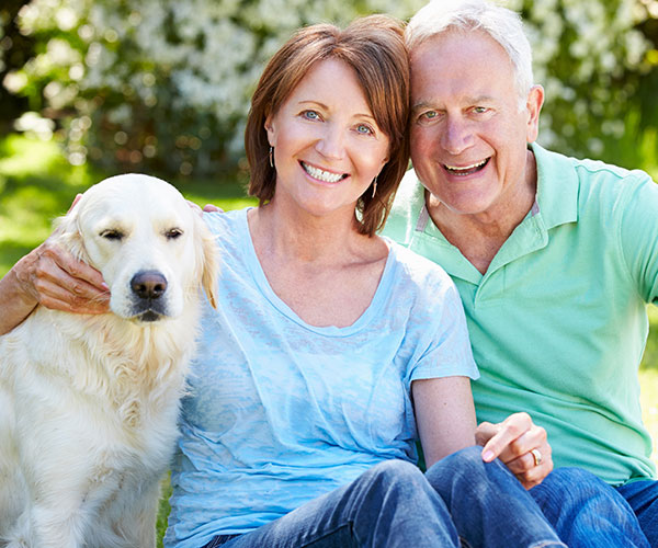 middle-aged couple with a dog